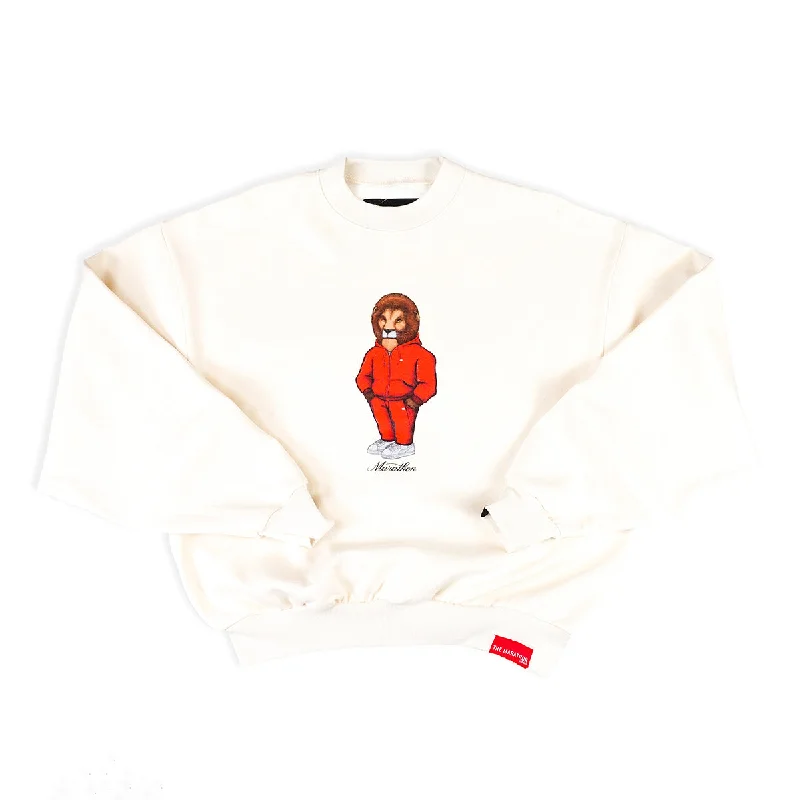 Women's cropped sweatshirt with a slogan graphic for a fun and expressive lookLeo The Marathon Lion (TMC Flag Sweatsuit) Crewneck - Bone Women's cropped sweatshirt with a slogan graphic for a fun and expressive lookLeo The Marathon Lion (TMC Flag Sweatsuit) Crewneck - Bone